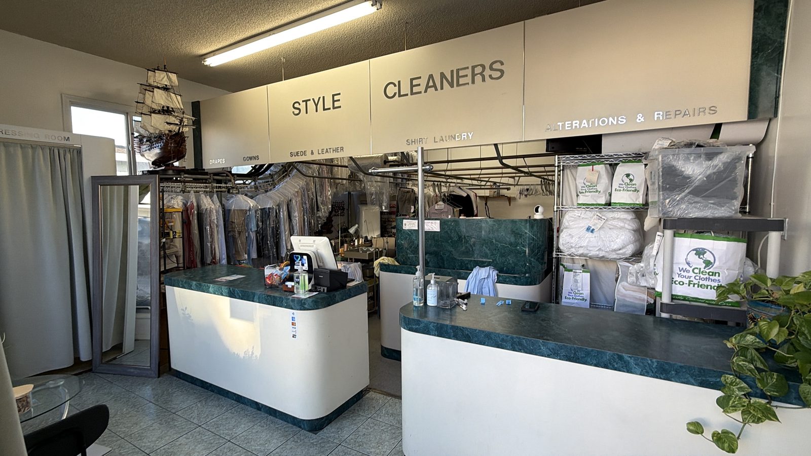 The front counter at Style Cleaners with reusable eco garment bags